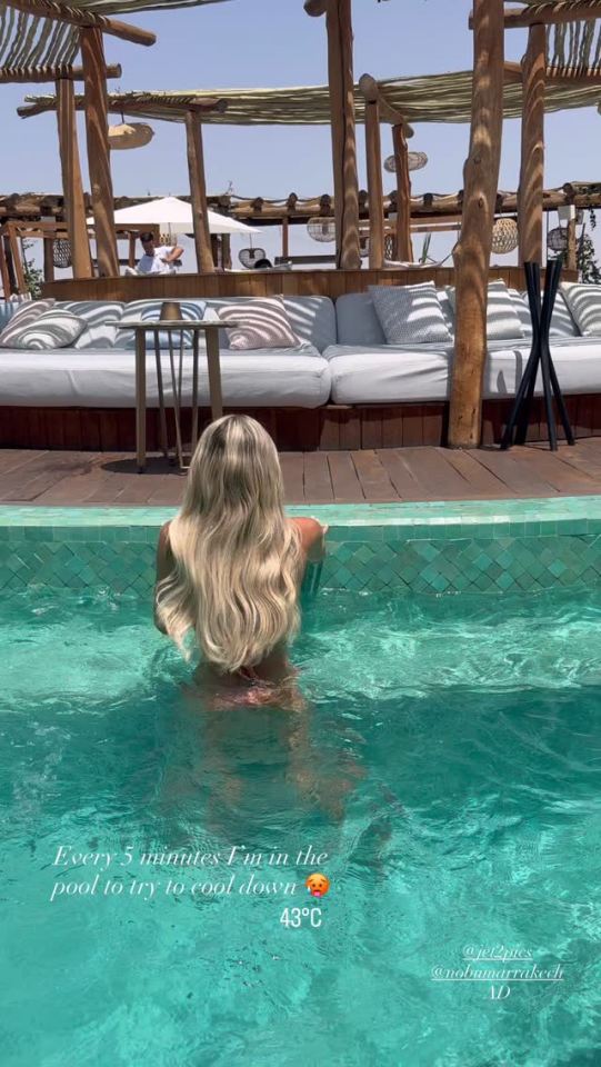 Woman cooling off in a pool at a Marrakech resort.