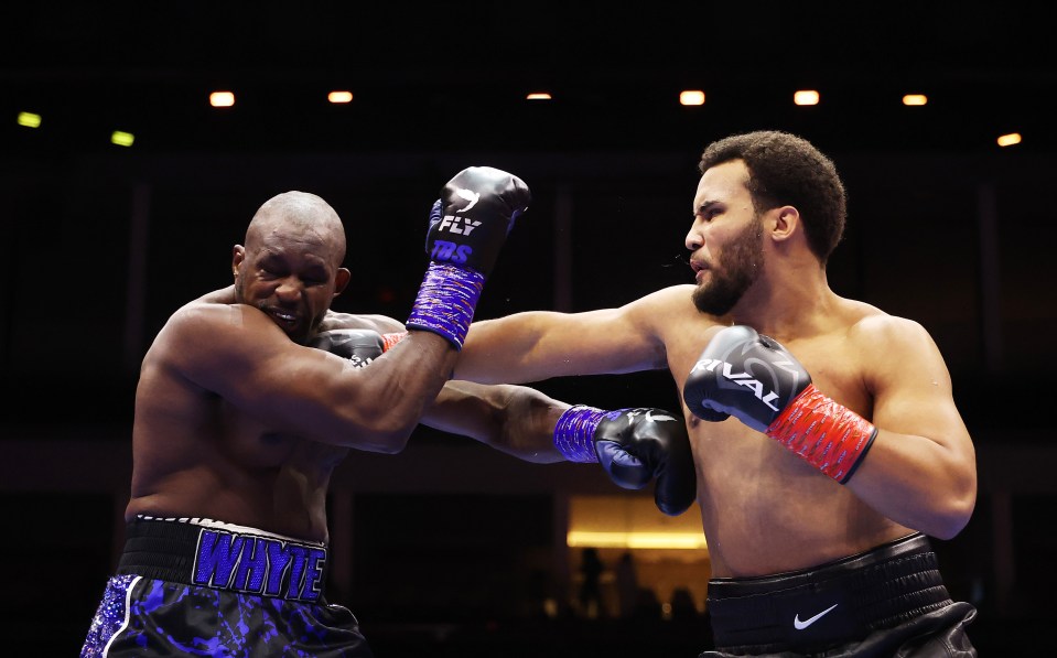 Moses Itauma punches Dillian Whyte during a boxing match.