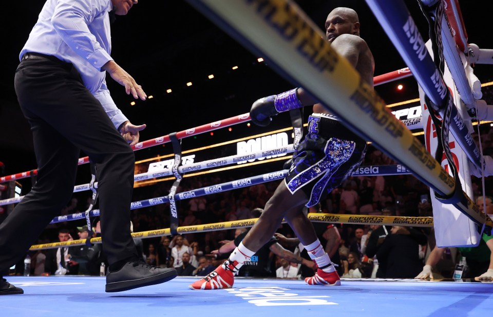 Dillian Whyte reacting after being knocked down in a boxing match.