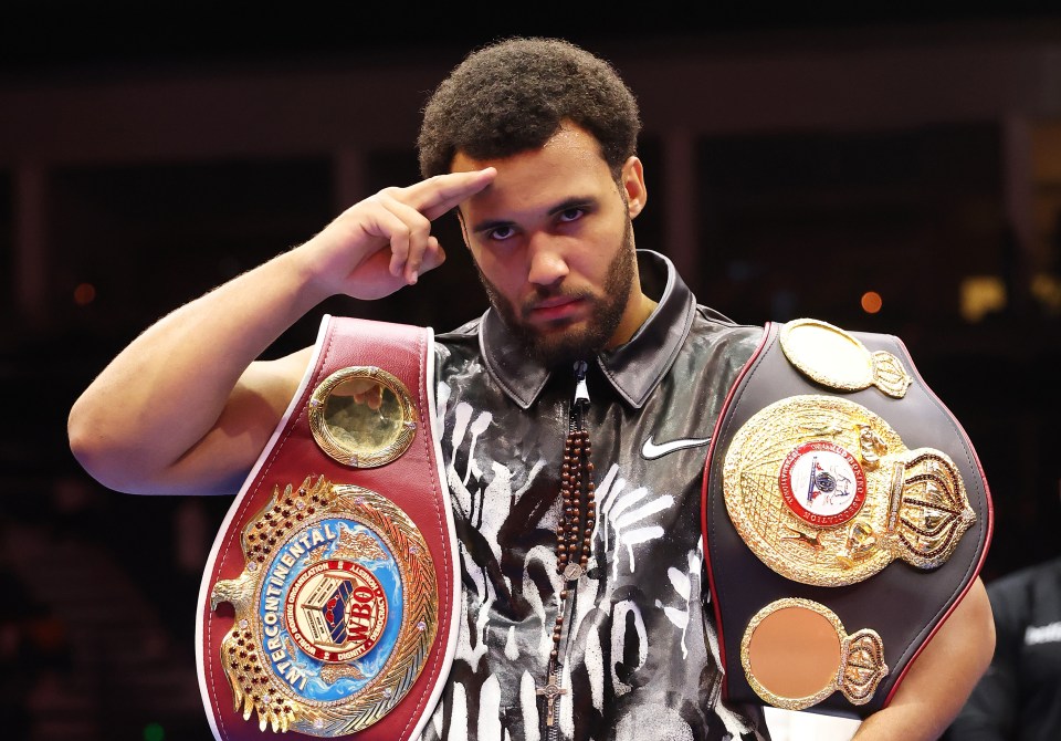 Moses Itauma posing with championship belts.