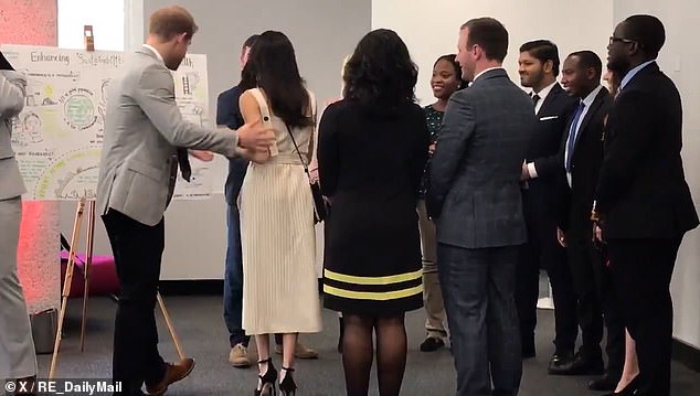 The Prince can be seen promptly stepping back, before apologising and allowing Meghan to take the lead