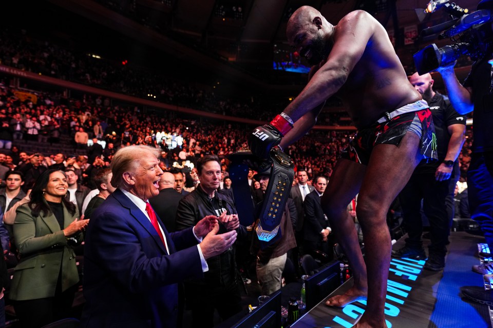 Donald Trump at a UFC event, congratulating a fighter holding a championship belt.