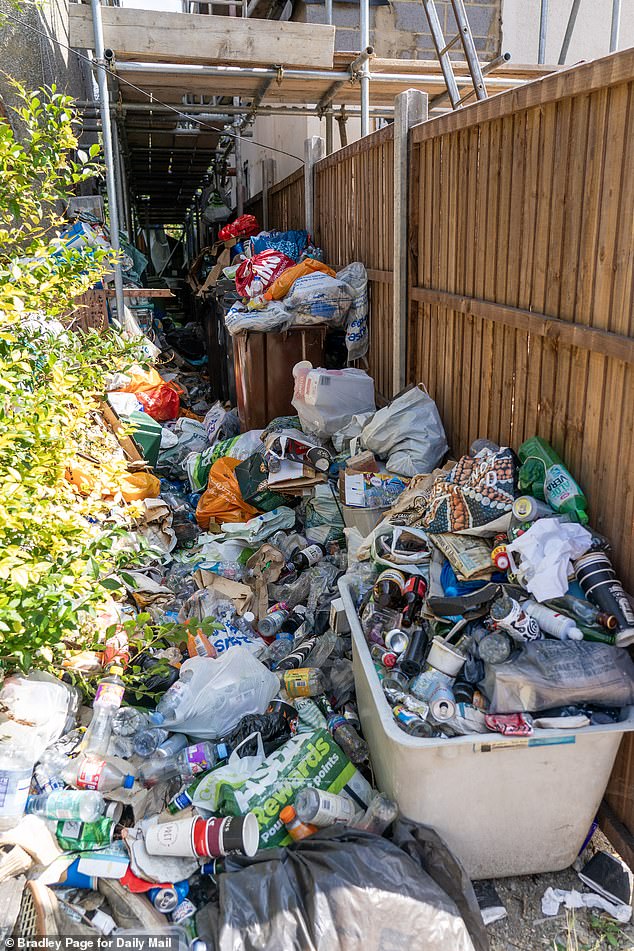 The garden path at the property in St Albans is full with burst bin bags full of recyclable waste