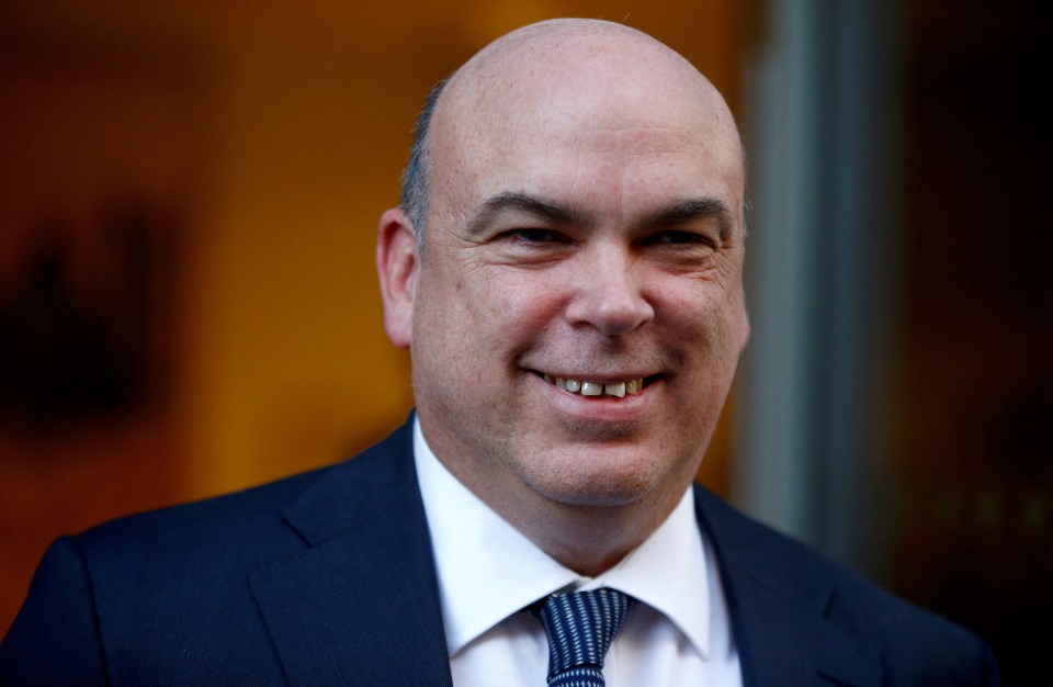 Headshot of a man in a suit.