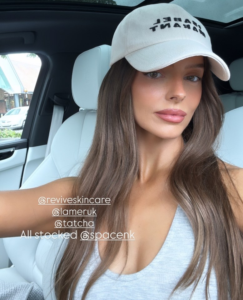 Woman in car promoting skincare products.