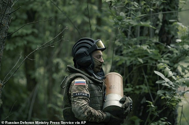 A Russian soldier carries an ammunition during a practice at a location in Ukraine on Friday