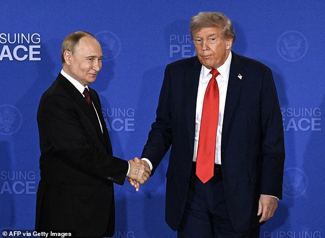 Donald Trump and Vladimir Putin shake hands after a joint press conference following the US-Russia summit on Ukraine at Joint Base Elmendorf-Richardson in Anchorage, Alaska, on Friday