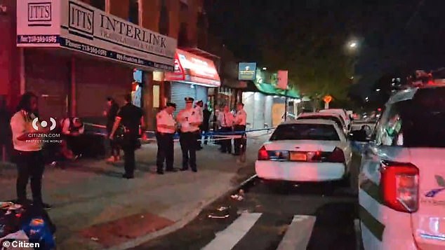 Officers are seen outside the Taste of the City Lounge where the shooting unfolded overnight