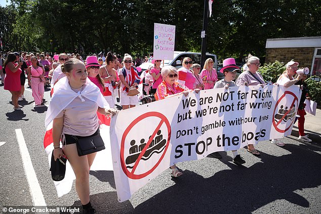 The Pink Ladies group march to demonstrate their opposition to the housing of asylum seekers