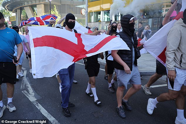 Photos from the London event today show demonstrators carrying England flags