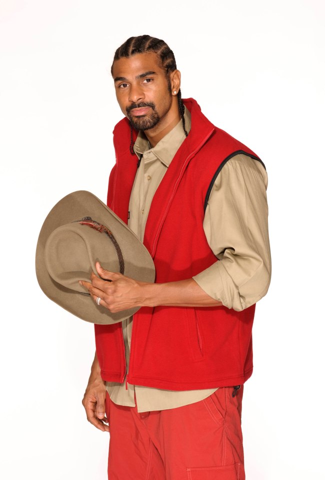 David Haye in red vest and khaki shirt, holding a hat.