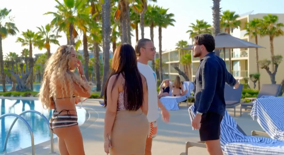 Screenshot of four people by a resort pool having a conversation.