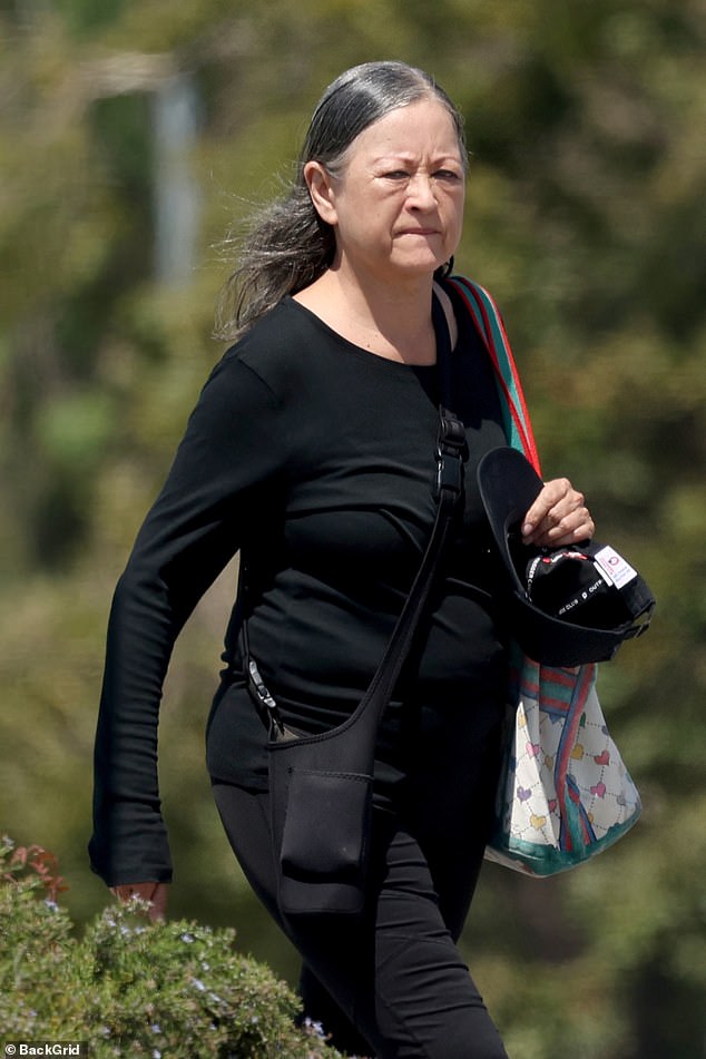 The 66-year-old Singapore-born actress, Julia Nickson was seen in a sleek, all-black outfit - long-sleeve top, flared leggings, sneakers, and a baseball cap - as she ran errands near her Los Angeles home, weaving through a street busy with construction crews
