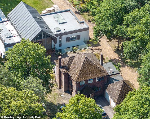 The older property (pictured in front of the new build) was set to be destroyed once the family moved into their mansion