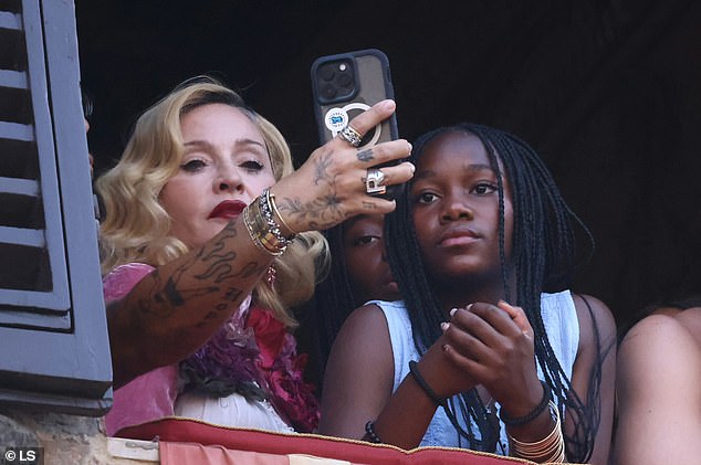 The musician was engrossed in the historic spectacle while flanked by her loved ones