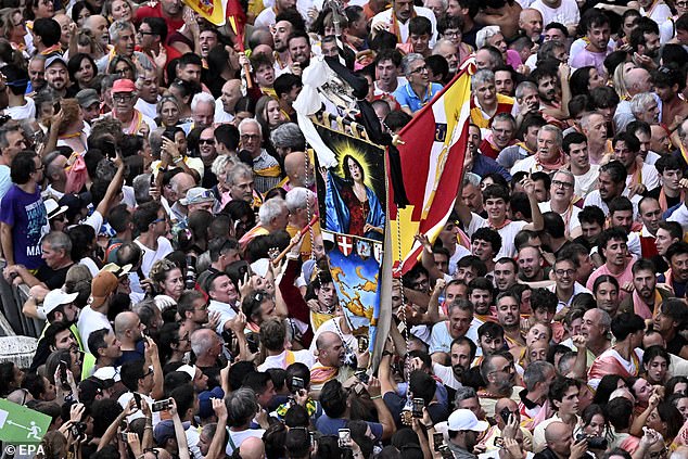 The first to cross the finish line of the three-lap race is rewarded with the Palio for their victorious neighbourhood to celebrate with