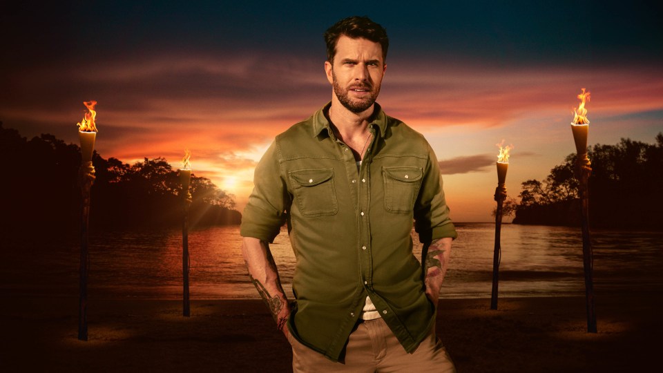 Joel Dommett on a beach at sunset.