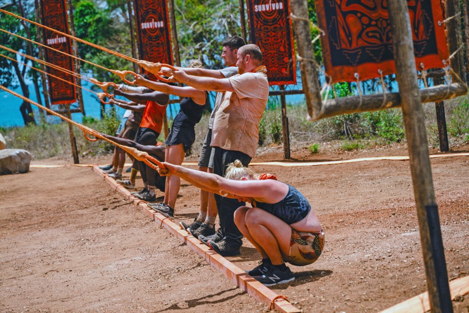 Contestants participating in a Survivor challenge.