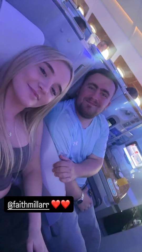 Couple seated in airplane seats.