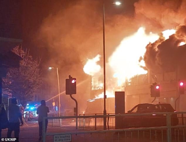 People watch on as a fire rips through Clacton town centre in the early hours of this morning