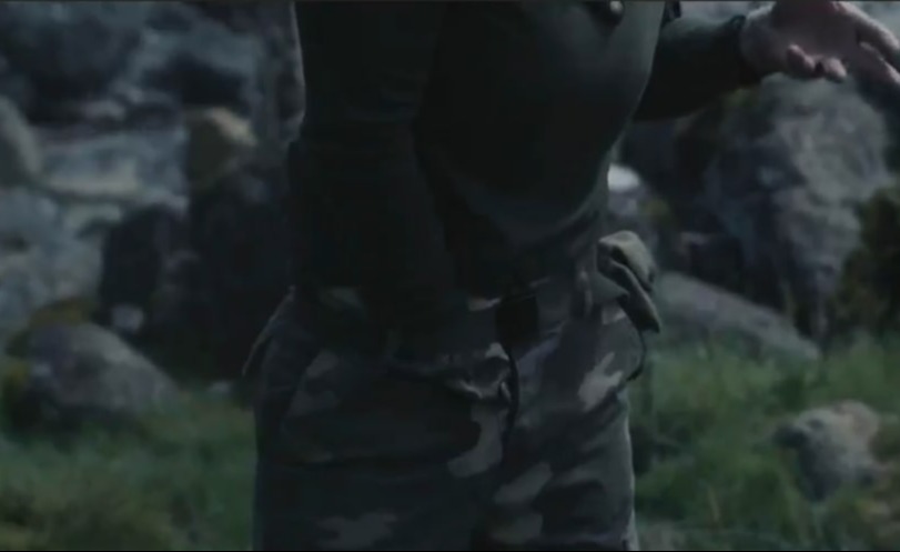 Lucy Spraggan in camouflage pants appearing to be in pain on *Celebrity SAS: Who Dares Wins*.