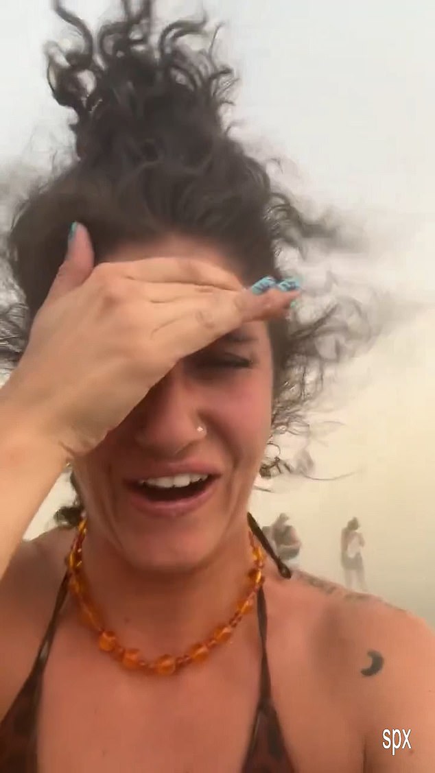 Bikini-clad sunseekers filmed themselves shielding their eyes as sand swirled around them and umbrellas trembled in the ferocious winds