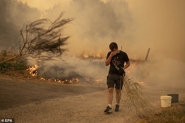 Local people battle a forest fire in Carballeda de Avia, Ourense, Galicia, north-western Spain, 17 August 2025