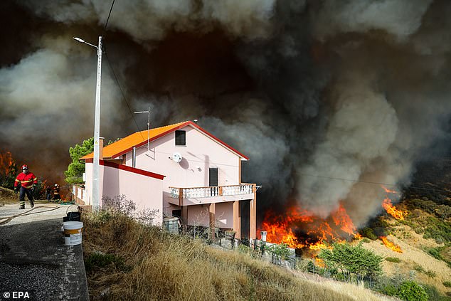 The forest fire approaches a house in Aldeia de Meas, Pampilhosa da Serra, Portugal, 17 August 2025