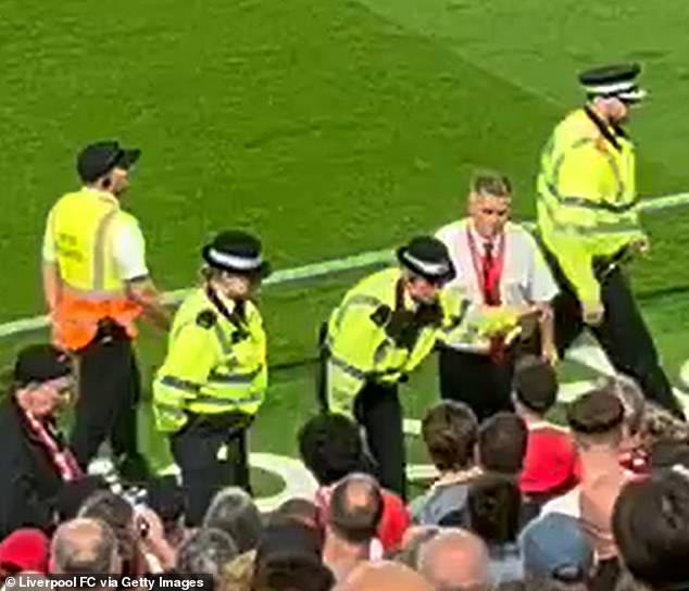 Police were seen speaking to a spectator later in the match before they removed a man from Anfield stadium