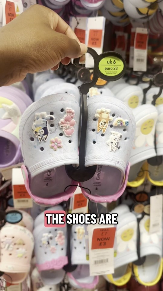 Child's light blue clogs with cartoon animal decorations, reduced to £3.