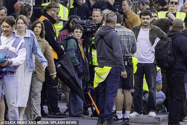 Scottish actor Dominic, 11, looked serious as he looked into the distance while rocking a blue, green and yellow rain jacket