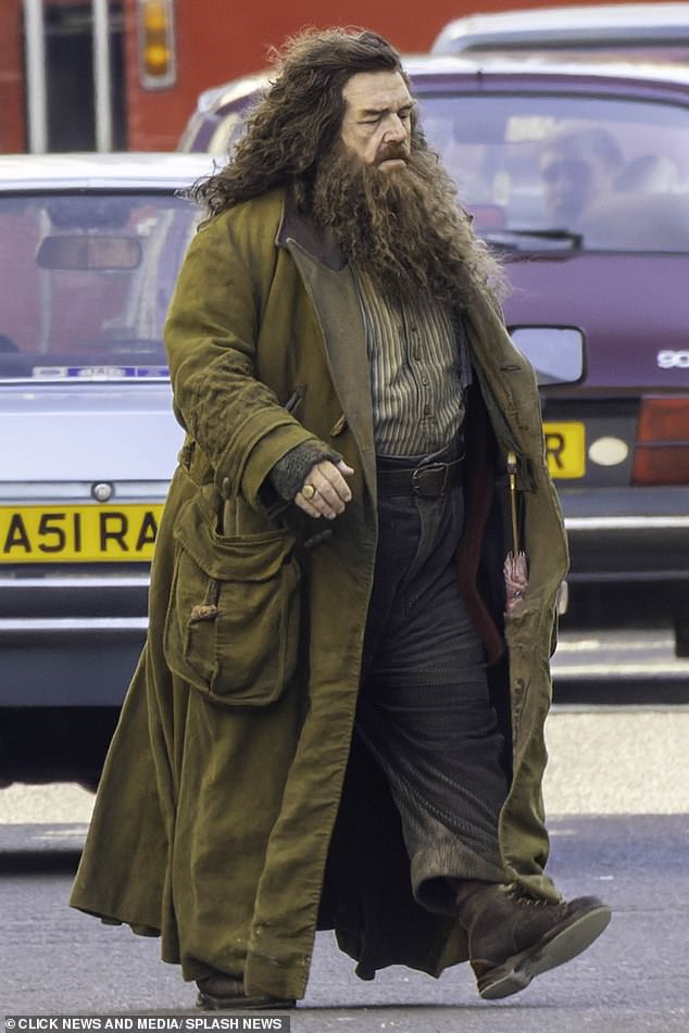Nick could be seen walking off the street and onto the pavement in a khaki jacket and brown trousers