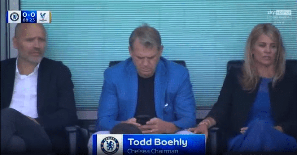Todd Boehly, Chelsea Chairman, on his phone with two others.