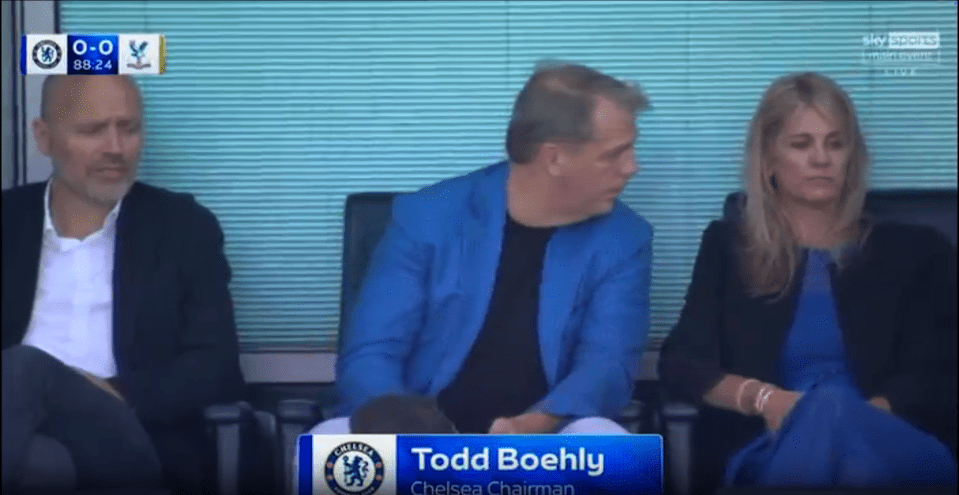 Todd Boehly, Chelsea Chairman, sitting with two other people.
