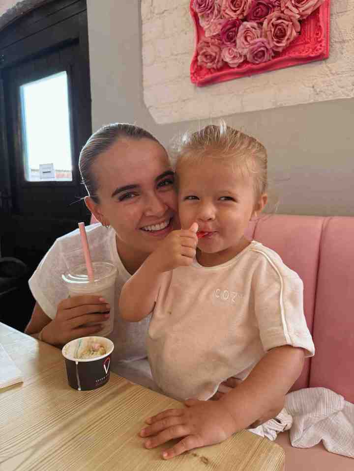 Woman and toddler enjoying ice cream.