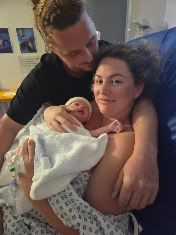 Parents holding their newborn baby.