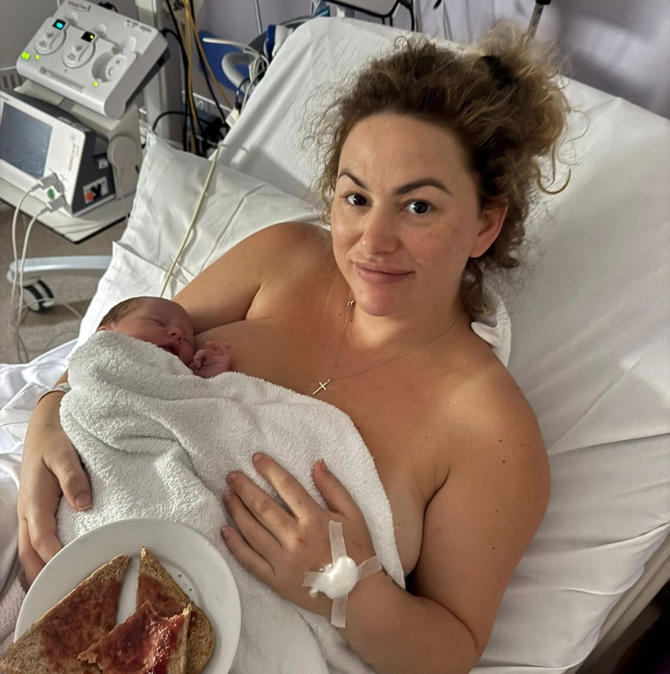 New mother holding her newborn baby in a hospital bed.