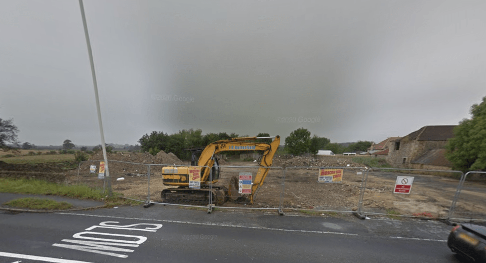 Excavator on an empty housing estate.