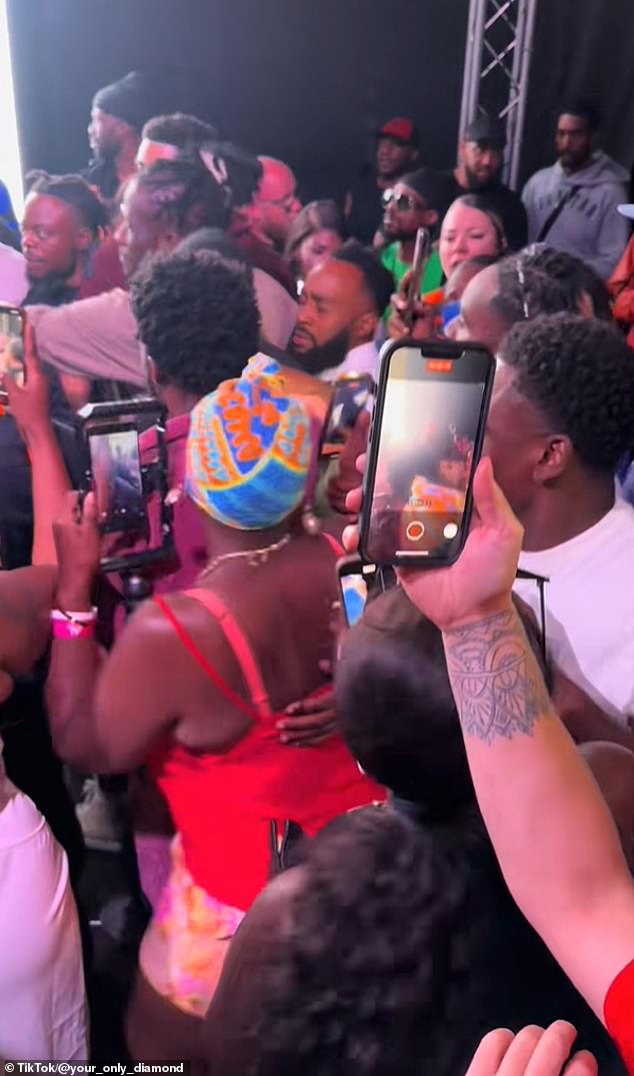The crowd had stormed the stage with the acts. Pictured: Aidonia, who was headlining, struggled to reach the stage