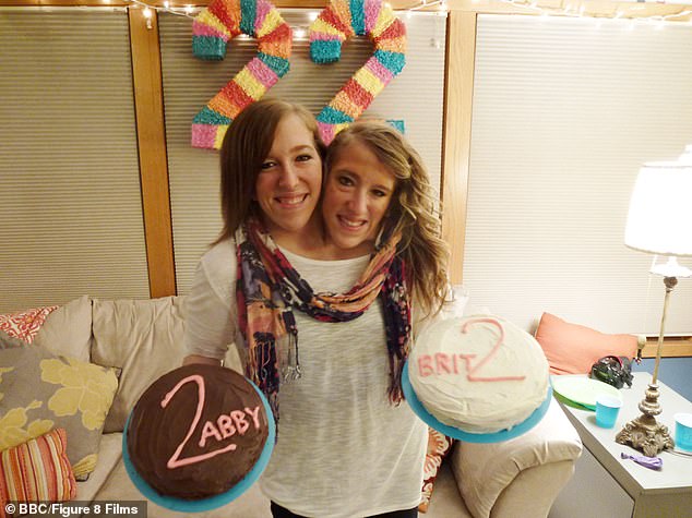 Abby and Brittany are pictured holding their separate birthday cakes as they celebrate their 22nd birthday