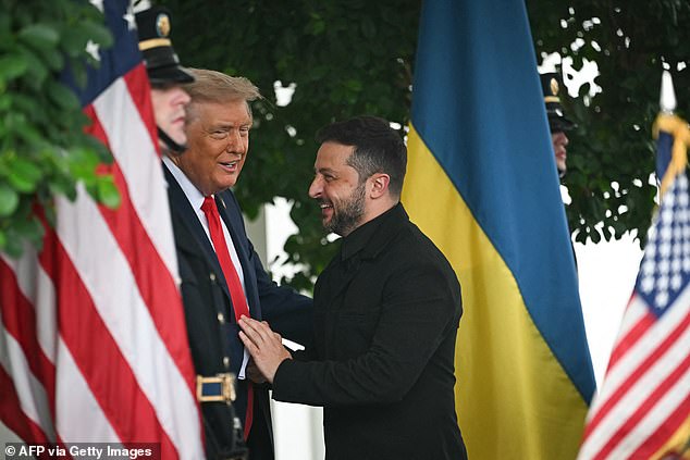The two leaders share a friendly greeting after an explosive showdown between the pair earlier this year