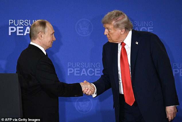 Donald Trump and Russian President Vladimir Putin shake hands at the end of a joint press conference after participating in a US-Russia summit