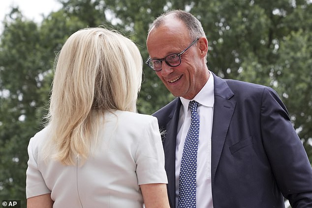 Germany's Chancellor Friedrich Merz greets Monica Crowley, White House chief of protocol outside the White House