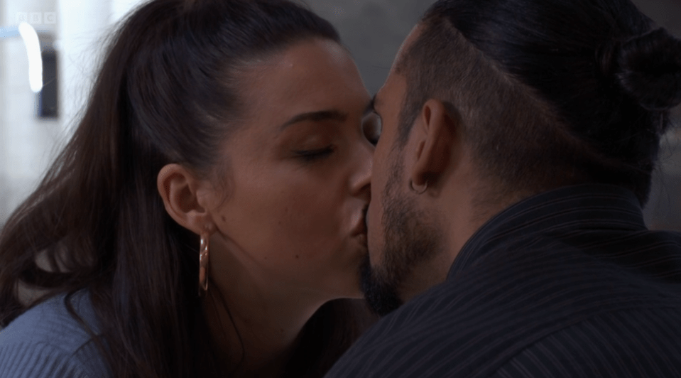 Screenshot of a couple kissing.