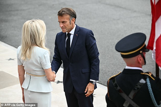French President Emmanuel Macron is greeted by US Chief of Protocol Monica Crowley