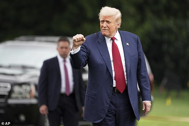 President Donald Trump waves his fist on the South Lawn of the White House on August 1