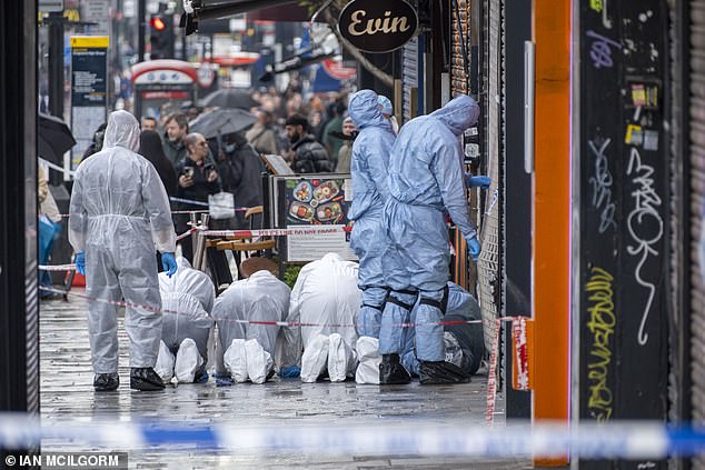 Forensic officers conducting a search outside the restaurant after the shooting in May 2024
