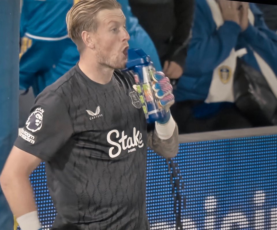 Goalkeeper drinking from a water bottle.