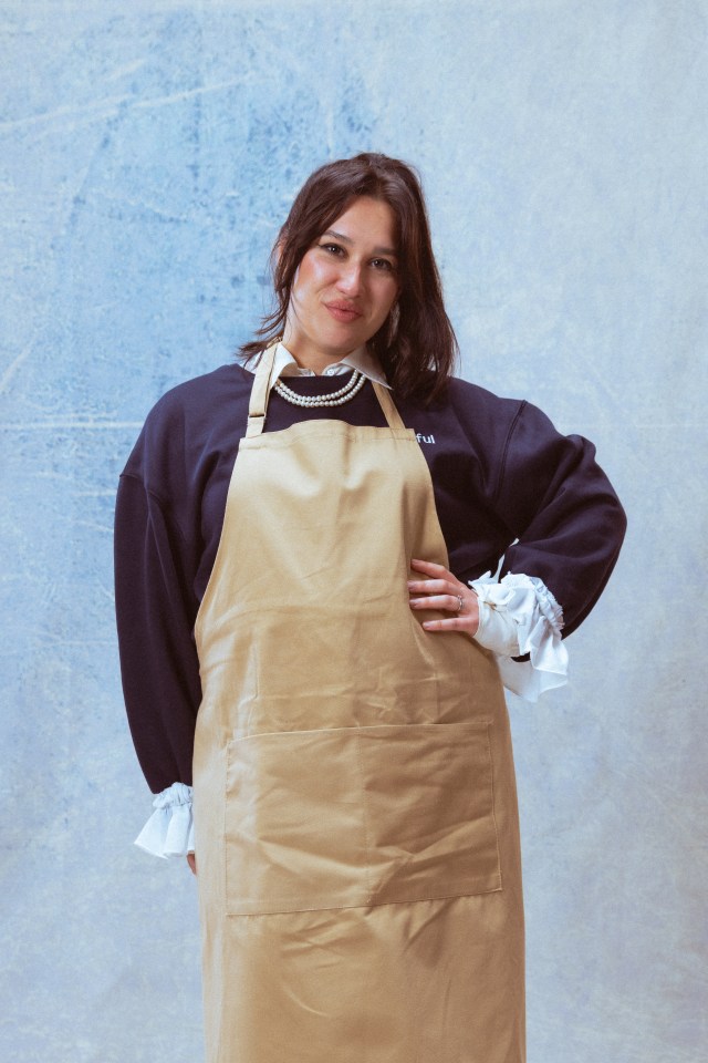 Woman wearing a tan apron.