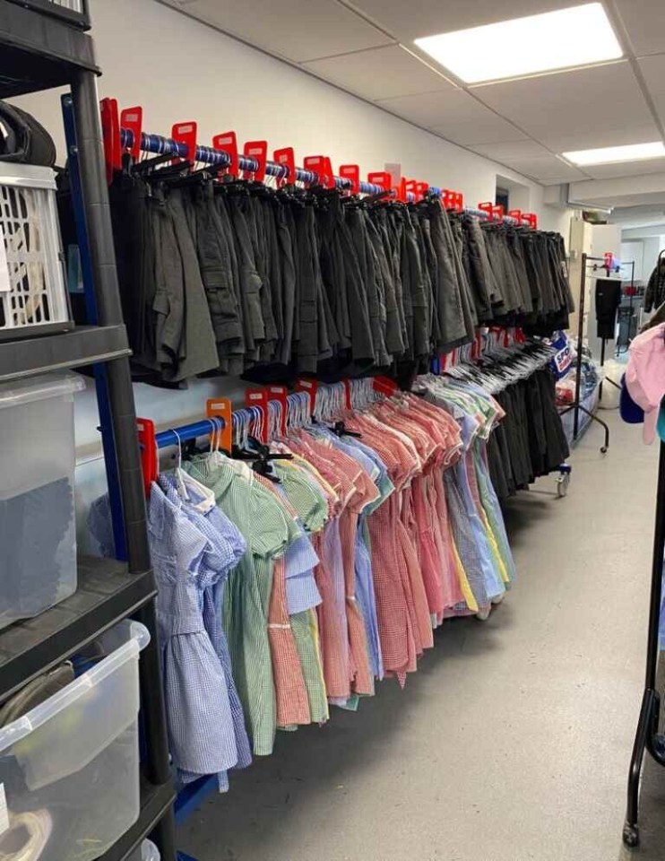 School uniforms hanging on racks.